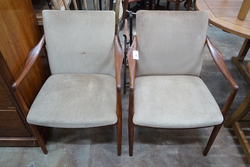 A pair of mid century teak upholstered elbow chairs, width 54cm, depth 63cm, height 84cm